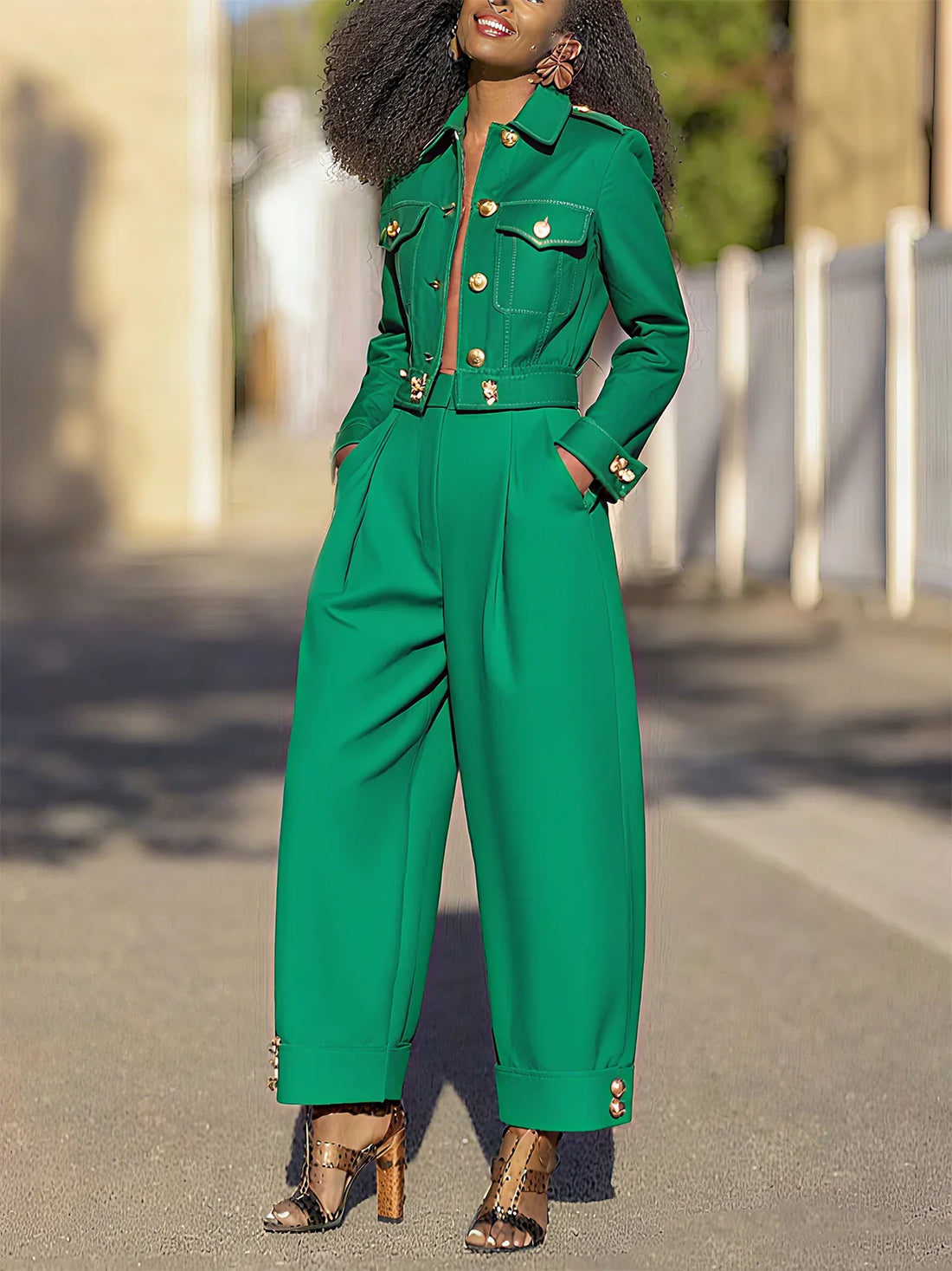 Woman wearing green urban plain buttoned fashion pants with side pockets and a matching green buttoned jacket