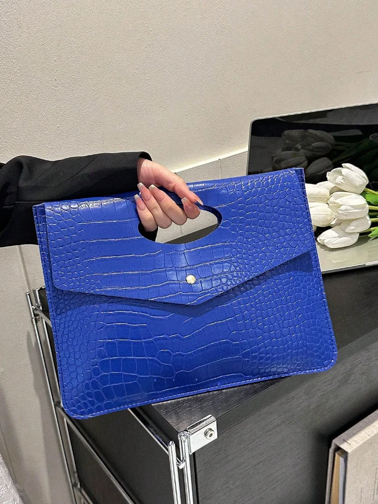 Blue PU classic backpack with crocodile texture and top handle being held by a person